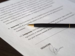 A contract with a pen.