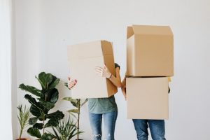 A couple carrying boxes.