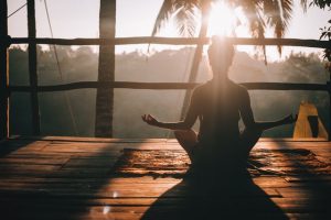 A woman who is meditating while taking a break due to the fears she has about selling her home