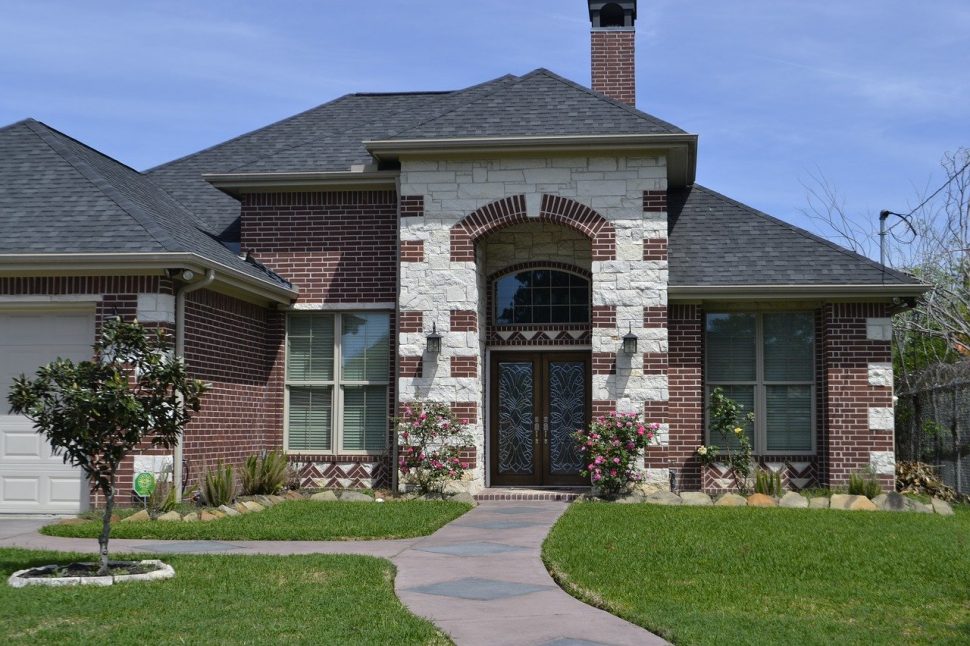 A house with a beautiful front yard and great curb appeal.