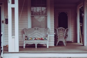 White wicker sofa on a porch.