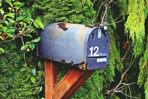 Blue rusted mailbox with number 12.