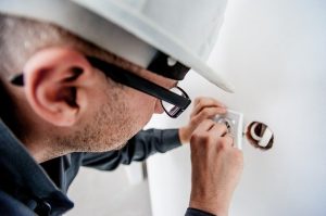 Electrician fixing power outlets. 