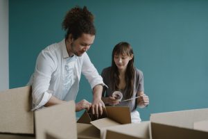 A man and a woman packing up boxes