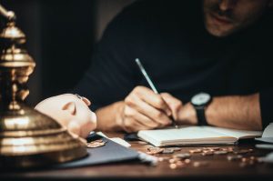 Man estimating his financial situation before he attempts to sell and buy a house at the same time