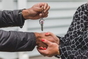 Woman shaking hand with a real estate agent