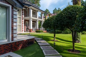 Neatly cut grass and trimmed trees with mulch