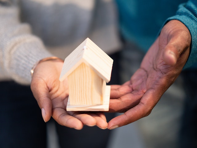 parents holding a small house after kids move out