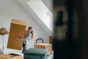 a woman carrying a moving box