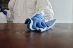 A person cleaning a table