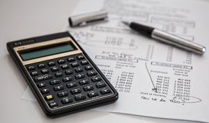 A calculator and pen on a paper