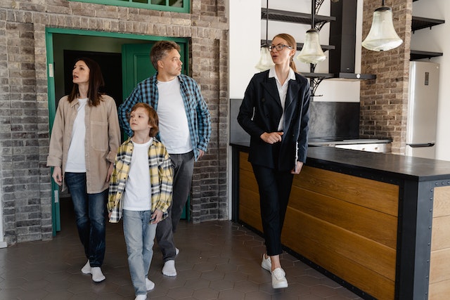 Real estate agent showing a property to a family with a small boy