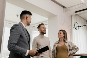 Real estate agent showing a property to a happy couple