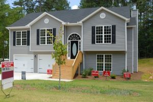 Home for sale with signs showing what's on offer