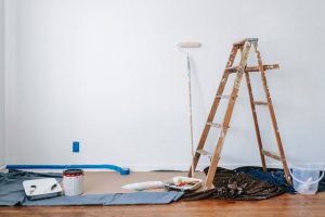 brown ladder and other material for painting in the middle of the room